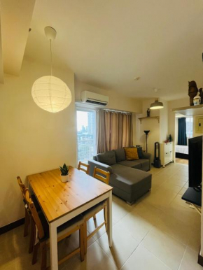 LOVELY & SERENE 2BR CORNER UNIT WITH BALCONIES, WIFI, NETFLIX and POOL ACCESS AT INFINA CUBAO QC